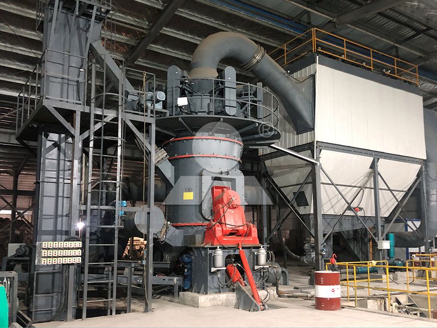 Operator monitoring automated control panel of vertical mill